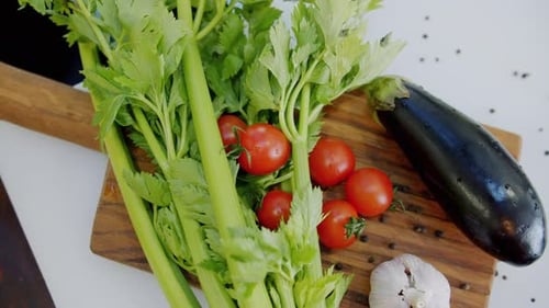 Top View of Wooden Cutting Board and Fresh Colorful Vegetables and Herbs