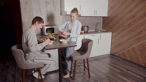 Young Couple Enjoying Breakfast Together in Kitchen