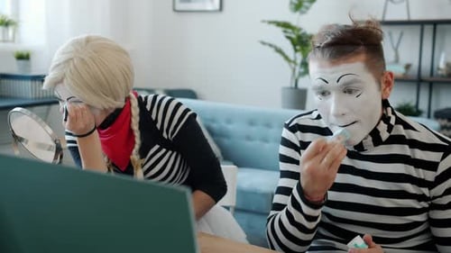 Mimes Applying Makeup Together in a Home