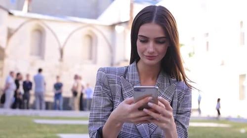 Young Woman Using Smartphone in an Urban Setting