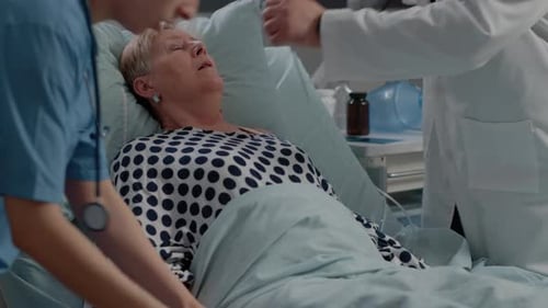 Woman Receiving Oxygen Mask from Doctor and Nurse