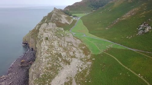 Aerial tracking and panning around from left to right above the rock stacks at the Valley of Rocks.
