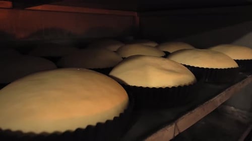 Jars for loaves of raw bread in bakery