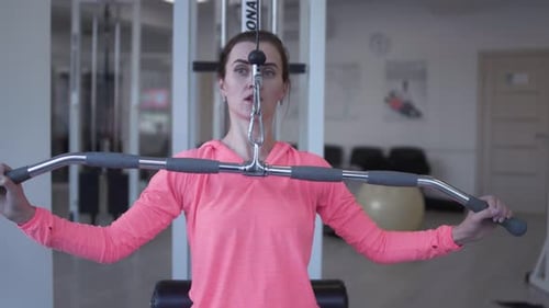 Female Raises Weight in the Gym People in the Gym Fitness Therapy