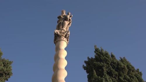 A statue on top of a column