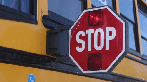 Front View of a School Bus Stop Paddle Being Extended