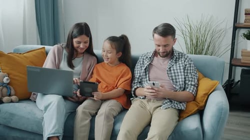 Family Relaxing at Home Using Electronic Devices