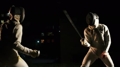 Fencers Sparring Outdoors at Night with Swords