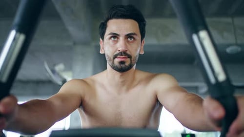 4K Portrait of Caucasian man workout exercise on cycling machine at gym.v