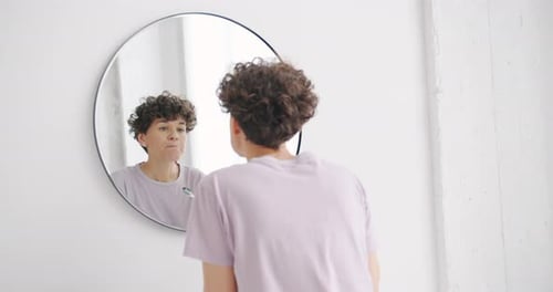 Woman Brushing Teeth in White Bathroom
