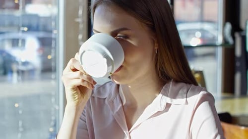 Woman Enjoying Coffee in Cafe