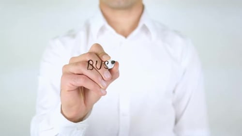 Man Writes 'Business Psychology' on Glass Surface