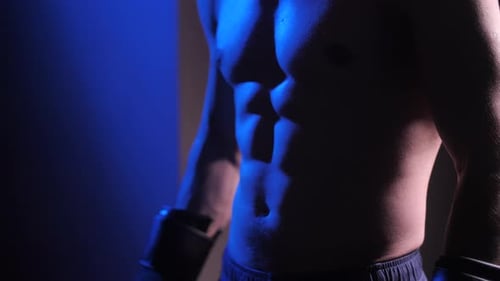 Close Up of Muscular Man with Boxing Gloves