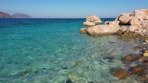 Crystal Clear Turquoise Sea Water Background and Rocky Coast