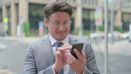 Man Using Smartphone in City Wearing Suit