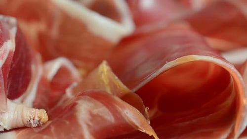 Jamon on the plate. Shooting in motion.