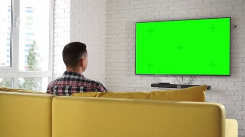 Man Watches Tv Set Green Screen