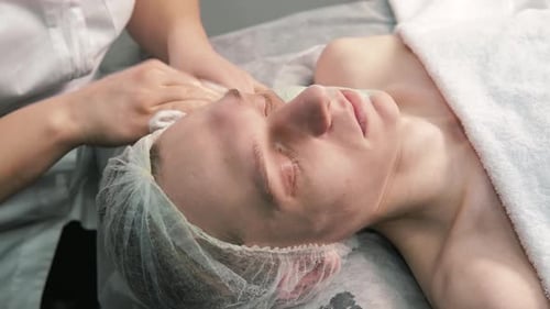 Woman Receiving Facial Treatment in Spa Environment
