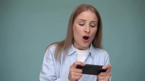 Woman Playing Mobile Game on Phone, Winning