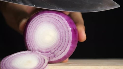 Chef slices shallot for cooking