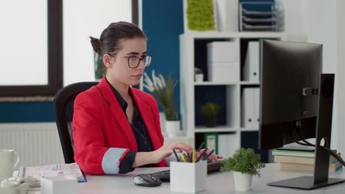 Woman Working on Computer in Modern Workplace