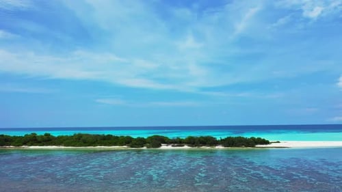 Aerial drone scenery of exotic shore beach break by blue green sea and white sand background of a da