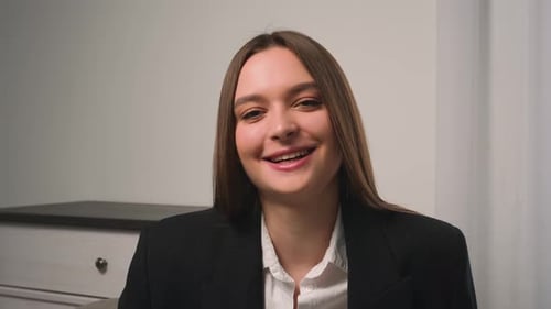 Confident Smiling Young Woman Looking at Camera Standing at Home Office
