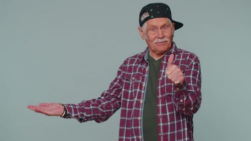 Senior Man Pointing Empty Place Advertising Area for Commercial Text Copy Space for Goods Promotion