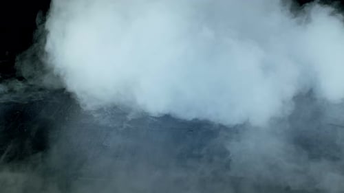 Swirling White Smoke Texture on Black Background