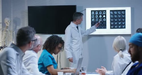 Medical Professionals Meeting Discussing Brain Scans