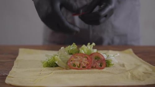 Preparing Fresh Wrap With Tomatoes and Lettuce
