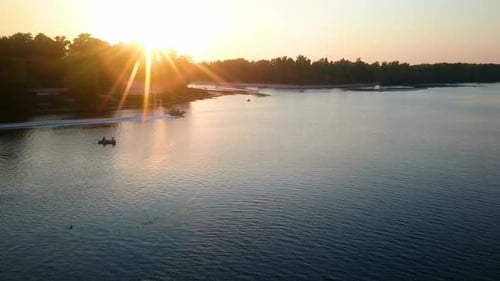 Beautiful Sunset Beams Reflecting in River Water, People Enjoying Relax on Boats