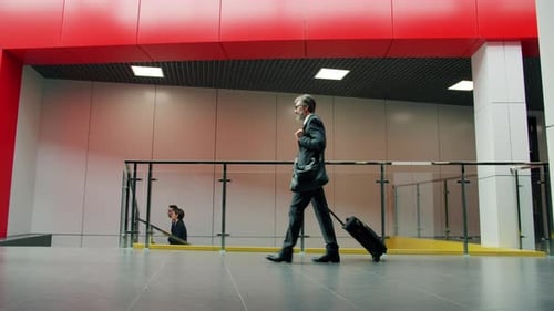 Slow Motion of Office Worker Walking in Business Center with Suitcase Going To Airport