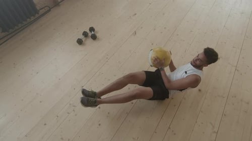 Top-View OF Afro Man Doing Crunches With Weight Ball