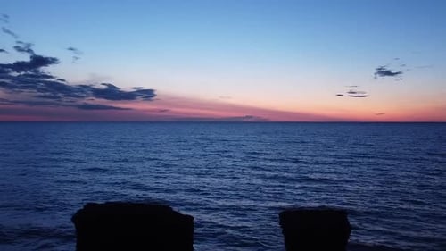 Beautiful aerial vibrant high contrast pink purple sunset over Baltic sea, Karosta war port concrete