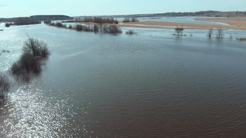 On a Sunny Spring Day the Camera Flies Fast and Low Over a Flooded Field