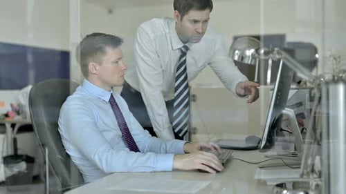 Two Businessman Having Discussion on Office Computer Screen About Project