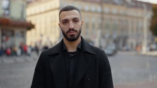 Arabian Man Standing on Street and Keeping Arms Crossed