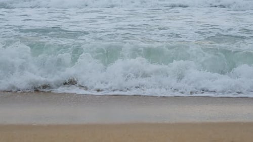 Beautiful sea waves and white sand beach in the tropical island. Beautiful view of the sunsets