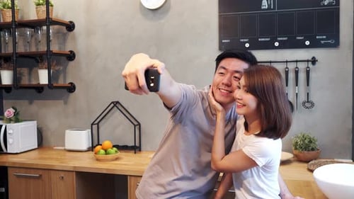 Happy Couple Taking Selfie Together in Kitchen