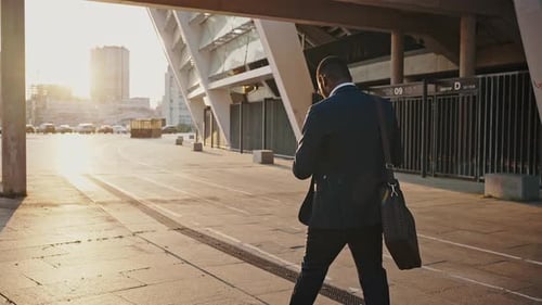 Confident Unrecognizable Black Businessman Going Along Evening City Back View Slow Motion Sun Flare