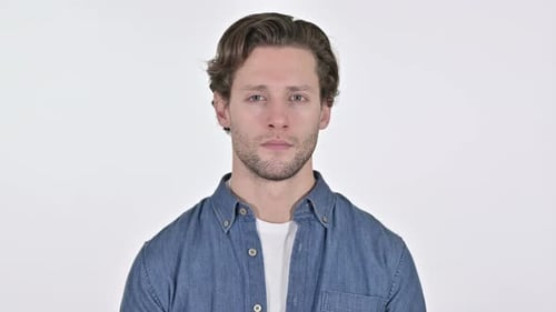 Serious Young Man Looking at Camera on White Background