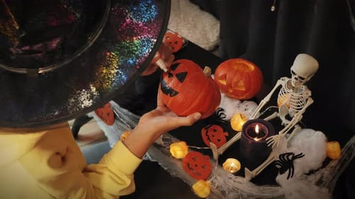 Child Decorating Halloween Pumpkin with Marker