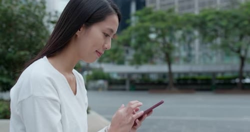 Woman use of mobile phone in city