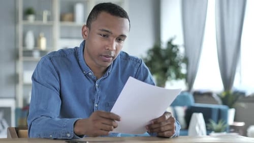 Man Reading Good News in Home Office