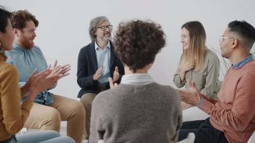 Group of Adults Talking in Bright Room