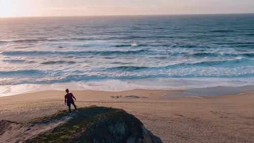 Fit Man is Standing On The Edge of the Cliff