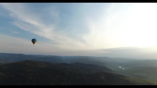 Large Balloon Flies Over a Beautiful Forest Scenery. Aerial View