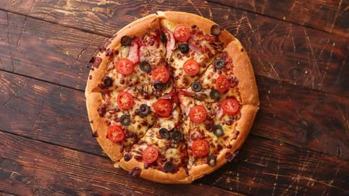 Delicious Tomato Olive Pizza on Wooden Table Top View