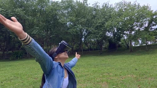 Woman Using VR Headset in Park
